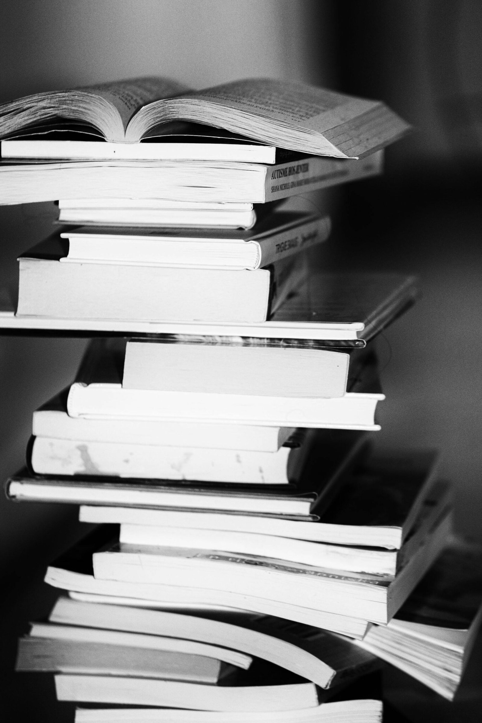 A monochrome image of a tall stack of books symbolizing education and knowledge.